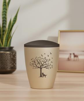 Preview: Dignified pet urn for dogs in beige with a velvety surface and brown lid, adorned with a pad printed motif of a tree of life, a dog, and flying birds – A symbolic memorial for the final farewell.